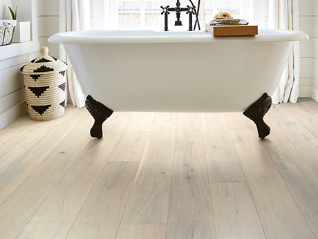 standalone white tub on flooring