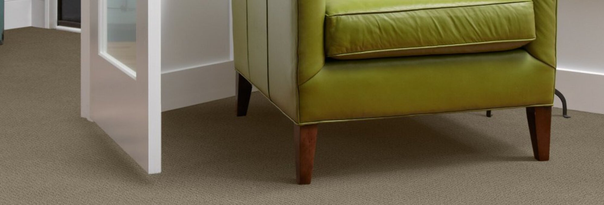 Green armchair on carpet - Carpet Clearance Warehouse in Keene