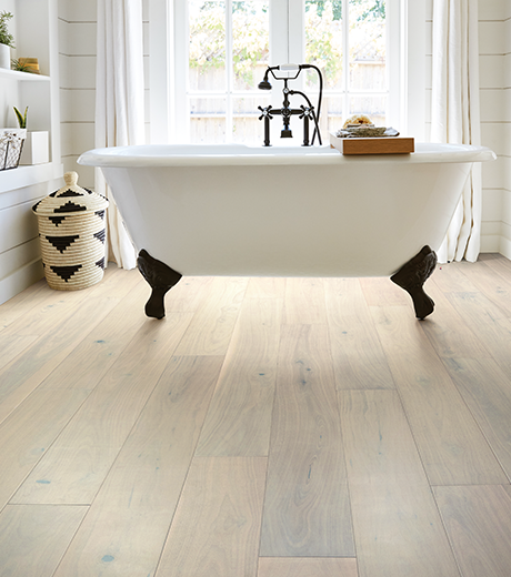 standalone white tub on flooring